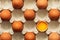 Brown eggs in a carton, one egg is broken. View from above