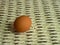 Brown eggs of light color prepare for the holiday Easter against the background from a white rope and dark branches of a