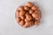 Brown eggs on a white plate on a white background. Eggs. Easter photo concept.