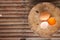 Brown eggs on a wooden chopping board There is a yolk in the egg shell. The brown egg has a drop of water because it is removing
