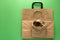 Brown empty kraft paper and linen case bags on green background. Top view. Eco packaging or packaging of meals concept