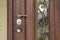 Brown entrance door with gold-plated handle and lock