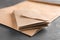 Brown envelopes on grey background, closeup. Mail service