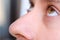 Brown eyes and nose of a young man close-up, concept of restoration of human vision, health of the optic nerve, nervous tic,