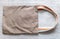 Brown fabric double handles sling Bag on gray