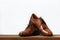 Brown fashion leather men shoes on table.