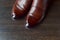 Brown fashionable men's brogue shoes on a dark background, top view