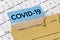 A brown file folder labeled with COVID-19