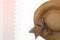 Brown floopy hat with ribbon and towel background. Top view. Sum