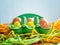 Brown fresh eggs with smiling faces in green tray with little chicken toys, Easter concept
