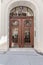 Brown front dual doors with a nice fanlight and wood carving decorations