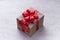 Brown gift box with red ribbon, light grey background flat lay for stock image