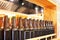 Brown glass bottles of beer in row on wooden shelf, bar interior design, beer tasting concept, nightlife style, brewery production