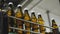 Brown glass water bottles are moving along the conveyor. Bottom view. Shop for the production of mineral water and soft drinks