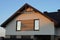 Brown gray attic of a private house with windows under a tiled roof