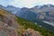 Brown and gray mountains with blue sky and white clouds.