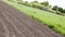 Brown ground plowed field, harrow lines. Arable background. A freshly ploughed field