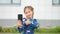 Brown-haired schoolgirl making selfies on black smartphone