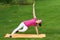 Brown haired woman training of side muscles of the body in equilibrium on a leg and a hand.