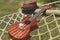 Brown hat and ukulele placed on a hammock