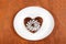 Brown heart shaped cookie with sugar powder