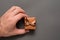 Brown jewelry box in man hand. Present. Black background