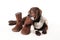 Brown labrador puppy chewing on boots with a scarf on a white b