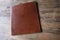 brown leather board on wooden background  Front Back Restaurant Menu Folder in Leather  empty mock up