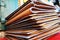 Brown leather books background on red table, close up