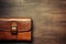 A brown leather case on wood table with copy space