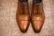 Brown leather classic male shoes on the floor