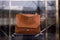 Brown leather handbag by Lancel in a uxury fashion store showroom