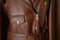 Brown leather jacket with. pocket and metal zippers on it.