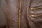 A brown leather jacket with zip half lowered