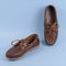 Brown leather men loafers shoes isolated on a blue background. Fashion advertising shoes photos