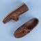 Brown leather men loafers shoes isolated on a blue background. Fashion advertising shoes photos..leather