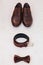 Brown leather men`s shoes with belt, bow-tie. Set groom accessories.