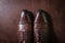 Brown leather men shoes on leather background, above shot