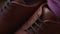 Brown leather shoes and the groom`s bow tie stand on the windowsill while getting ready close-up