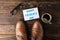 Brown leather shoes, inscription happy fathers day, cup of coffee and glasses on wooden background, space for text