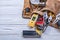 Brown leather tool belt with building implements on wooden board