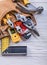 Brown leather toolbelt with construction tools on wood board dir