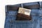 A brown leather wallet filled with 200 PLN Polish banknotes inserted into the back pocket of blue denim pants.