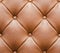 Brown Leathered Sofa with Buttons Texture Seamless Background