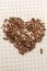 Brown leaves form heart shape on brown background