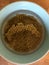 Brown lentils soaking in water in a bowl