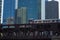 Brown line el train crosses the Wells St elevated train tracks with skyline in background