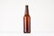Brown longneck beer bottle mock up. Template for advertising, design, branding identity on white wood table.