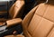 Brown luxury modern car Interior. Detail of modern car interior. Part of brown leather seats with red stitching in expensive car