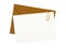 Brown manila envelope, blank letter or message card, paper clip, white copy space